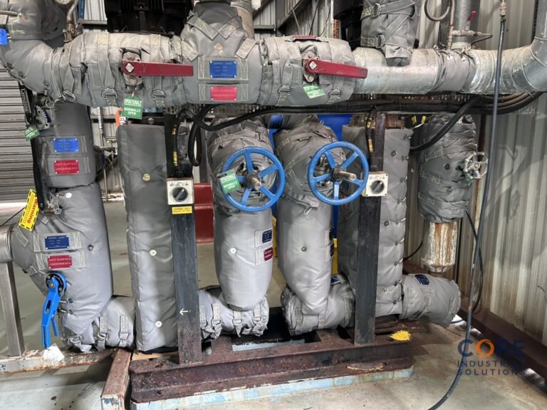 Industrial pipework fitted with insulation covers and valve wheels