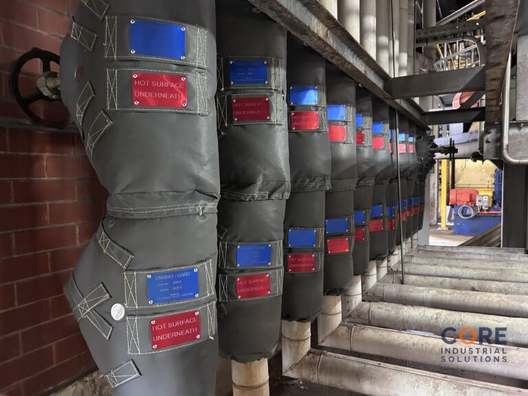 Row of industrial valves fitted with removable insulation jackets