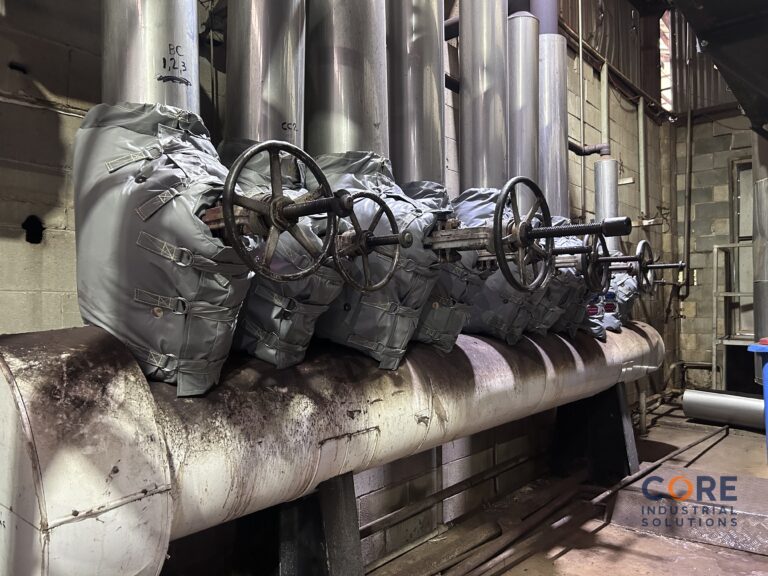 Insulation jackets fitted to row of industrial valves