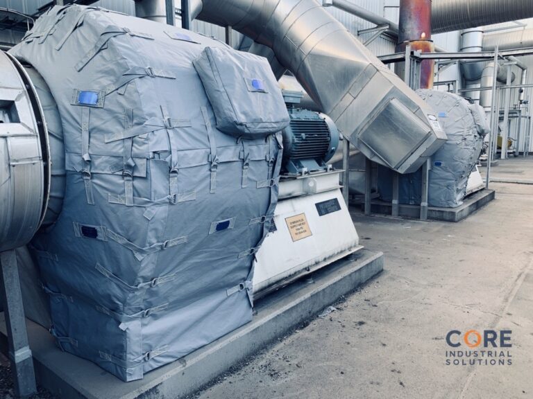 Large industrial fan and blower assembly wrapped in custom removable insulation blankets