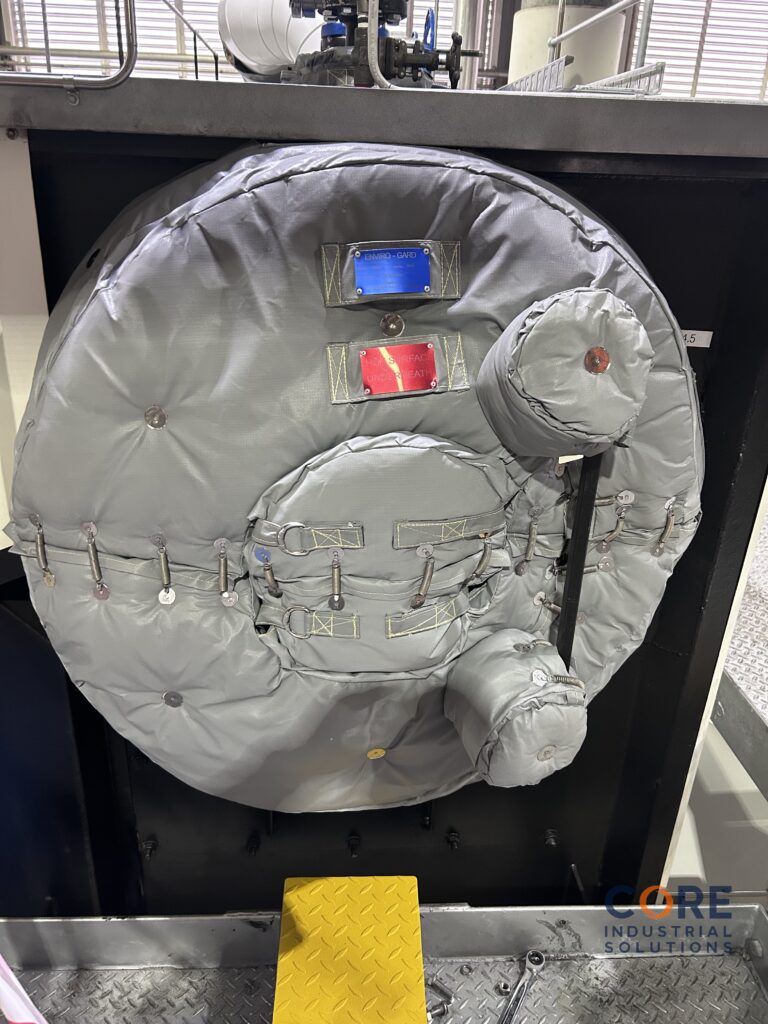 Removable insulation cover on meat rendering plant vessel